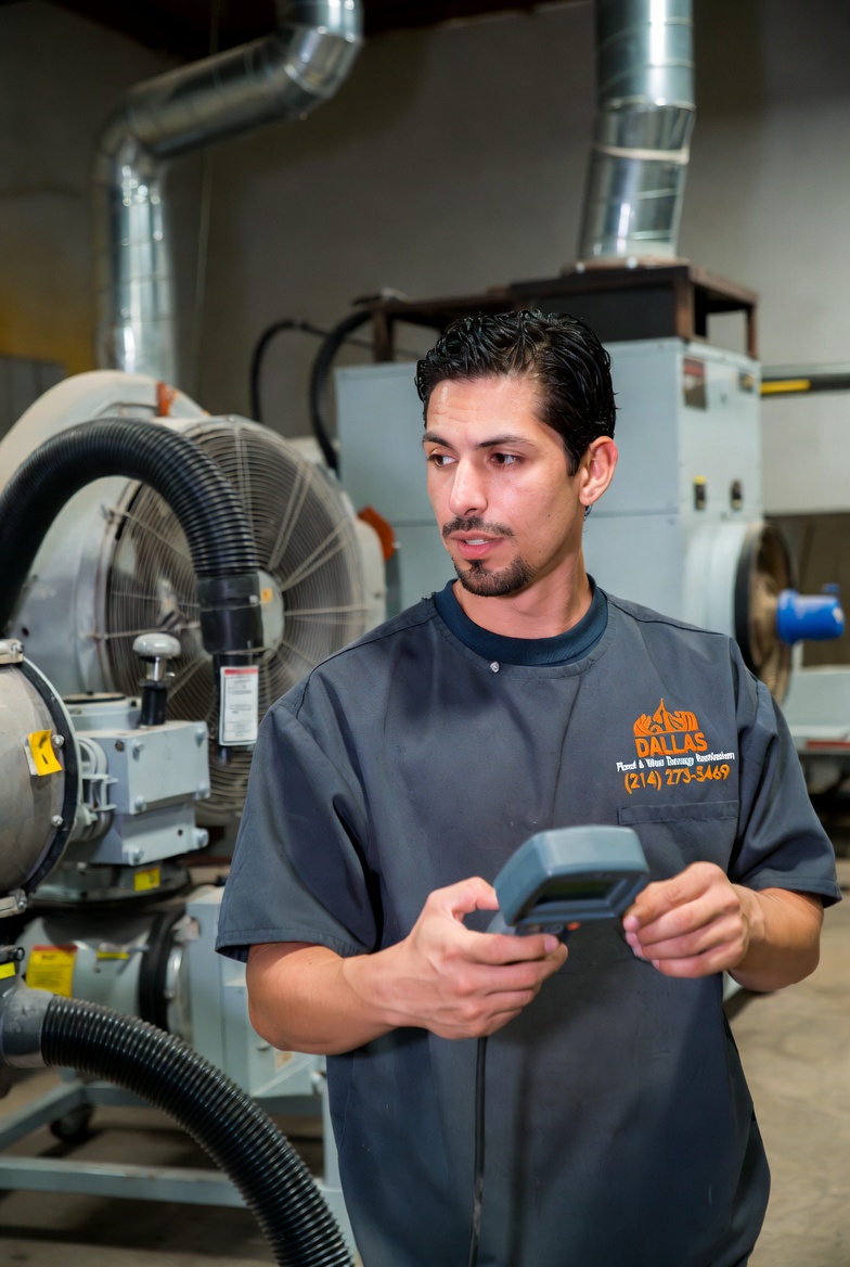 IICRC-certified water damage restoration technician with moisture detection equipment in Dallas